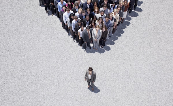 Businesswoman at apex of crowd